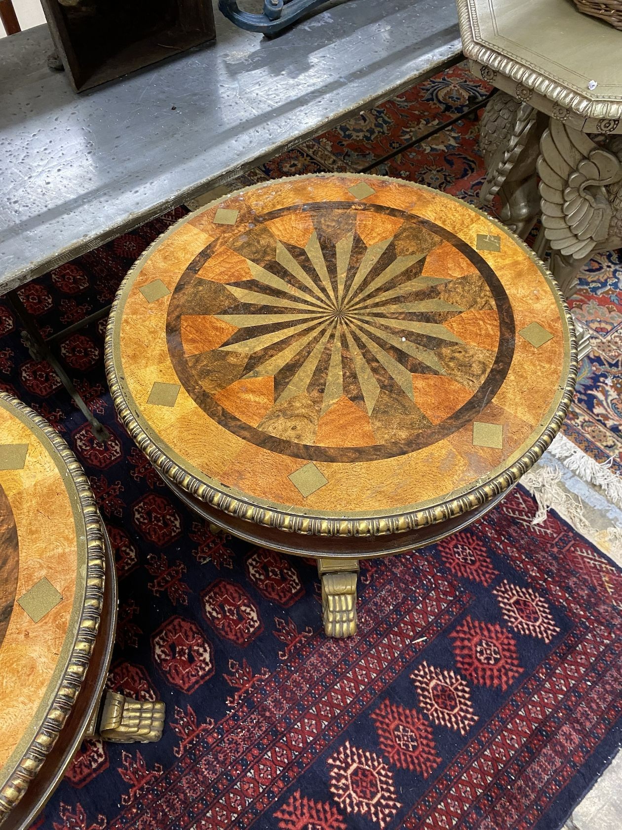 A pair of Empire style circular wood and composition faux parquetry occasional tables, diameter 69cm, height 69cm